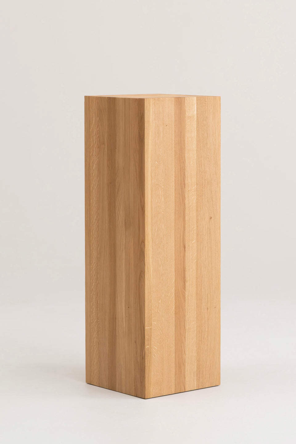 Clean vertical silhouette crafted from solid oak, walnut, or smoked ash.
