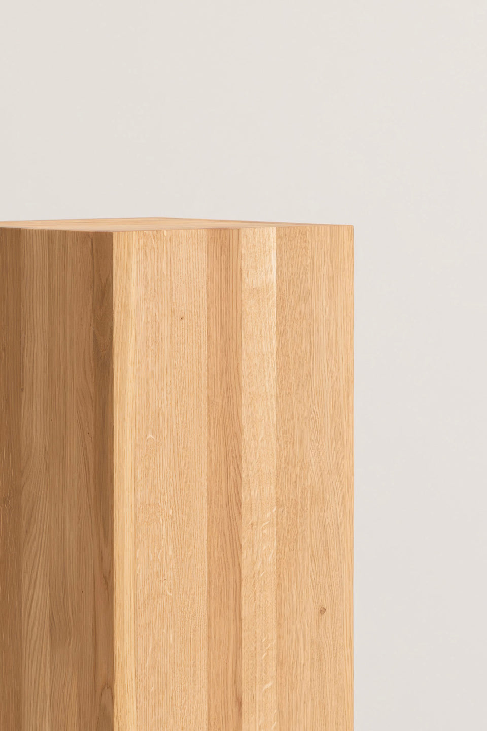 Minimalist form designed to emphasize the object it supports.