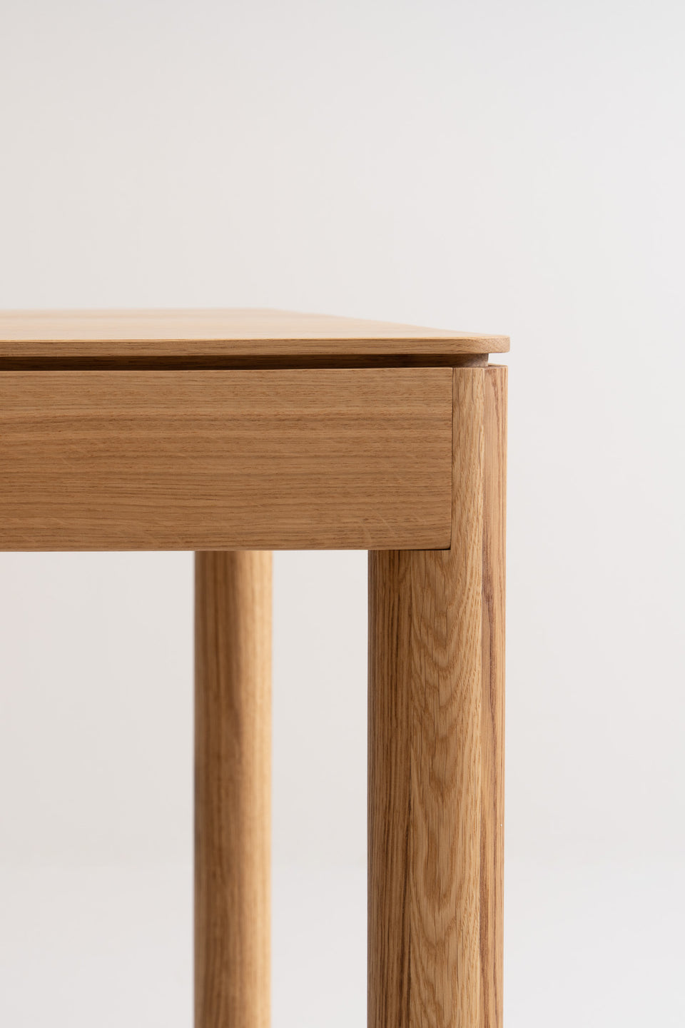 Floating tabletop effect with shadow gap and curved legs.